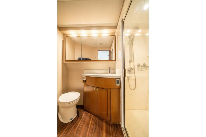 Slide: The Image of Luxurious bathroom in 2020 Cabo 40 Express yacht with modern fixtures and wooden cabinetry. - 16
