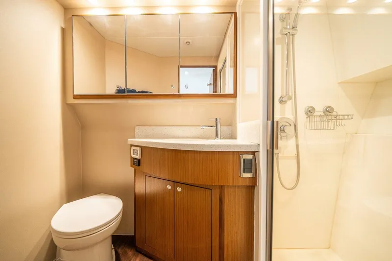 Slide: The Image of Luxurious bathroom in 2020 Cabo 40 Express yacht with modern fixtures and wooden cabinetry. - 17