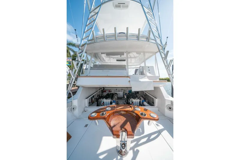 Slide: The Image of 2020 Cabo 40 Express yacht with fishing cockpit and ladder, docked under clear skies. - 19