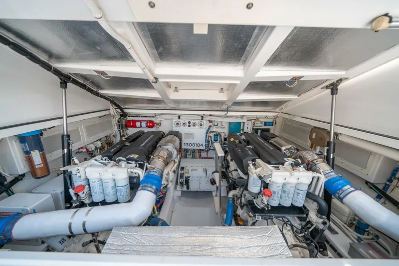 Slide: The Image of Engine room of 2020 Cabo 40 Express boat, showcasing dual engines and equipment. - 2