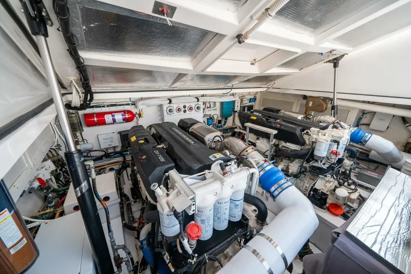Slide: The Image of Engine room of 2020 Cabo 40 Express yacht, featuring dual engines and equipment. - 24