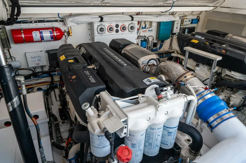 Slide: The Image of Engine room of 2020 Cabo 40 Express boat with Volvo Penta engines and fire extinguisher. - 25