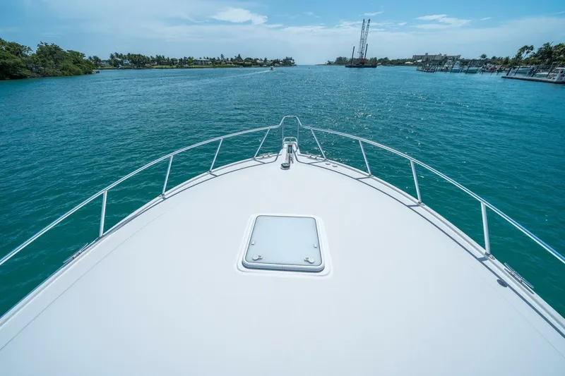 Slide: The Image of Bow view of 2020 Cabo 40 Express yacht cruising on clear blue waters. - 27