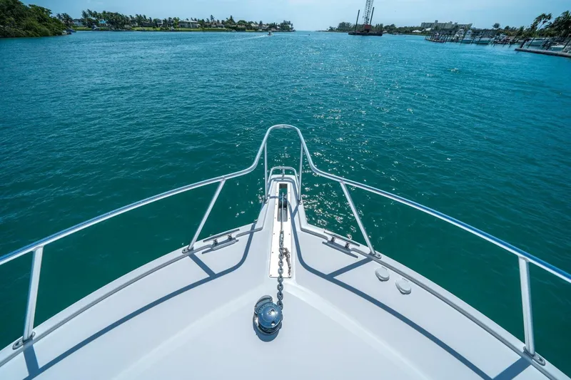 Slide: The Image of Bow view of 2020 Cabo 40 Express yacht cruising on clear blue waters. - 28