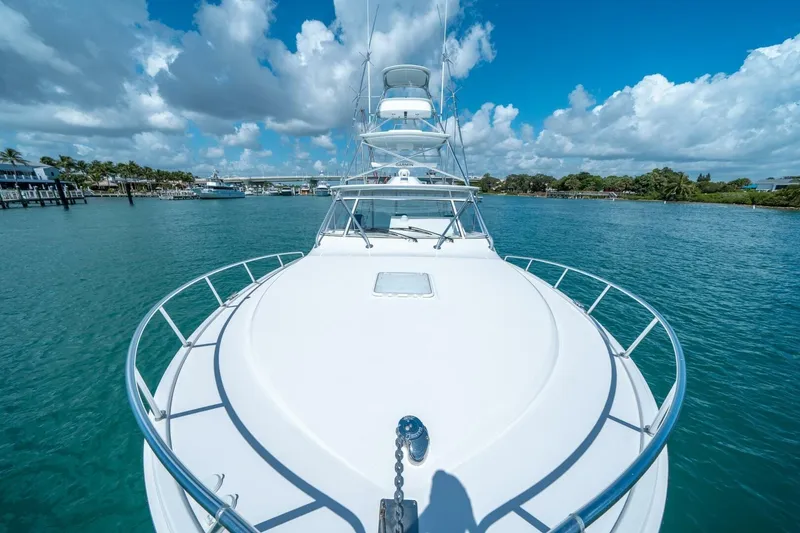 Slide: The Image of Cabo 40 Express 2020 yacht on clear blue water under a vibrant sky. - 29