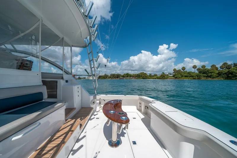 Slide: The Image of 2020 Cabo 40 Express yacht deck with scenic water view and clear blue sky. - 35
