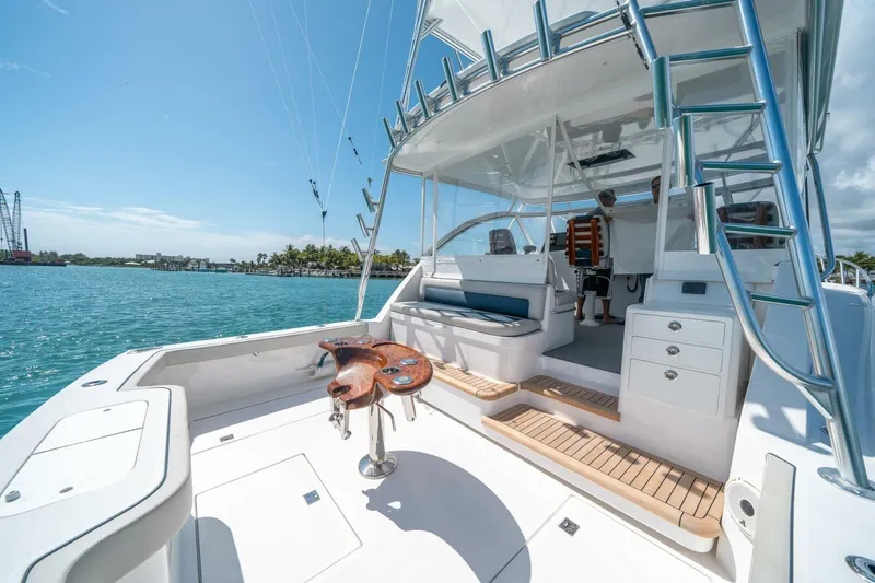 Slide: The Image of 2020 Cabo 40 Express yacht with spacious deck and fishing chair on sunny day. - 36