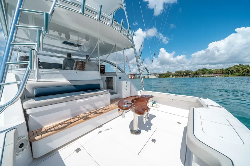 Slide: The Image of 2020 Cabo 40 Express yacht with spacious deck, blue skies, and scenic waterway. - 37