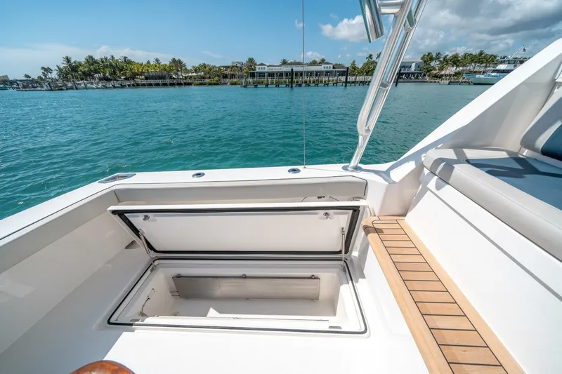 Slide: The Image of 2020 Cabo 40 Express yacht with open storage compartment, dockside view. - 40