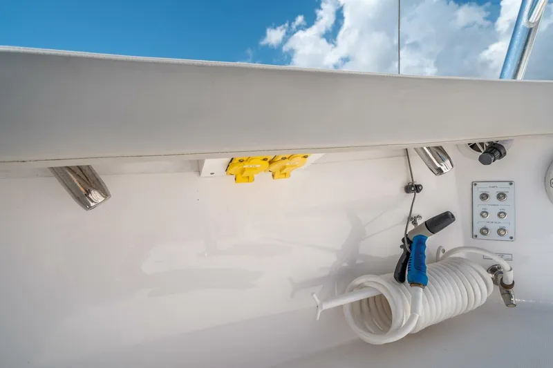Slide: The Image of Cabo 40 Express 2020 boat deck with coiled hose and control panel under blue sky. - 42