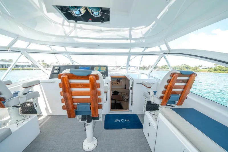 Slide: The Image of 2020 Cabo 40 Express yacht interior with helm chairs and panoramic windows. - 45