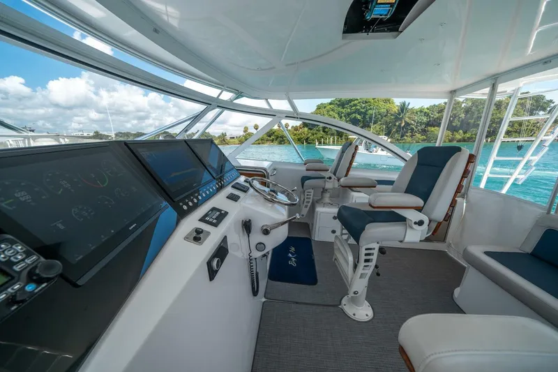 Slide: The Image of 2020 Cabo 40 Express yacht cockpit with modern navigation equipment and luxurious seating. - 50