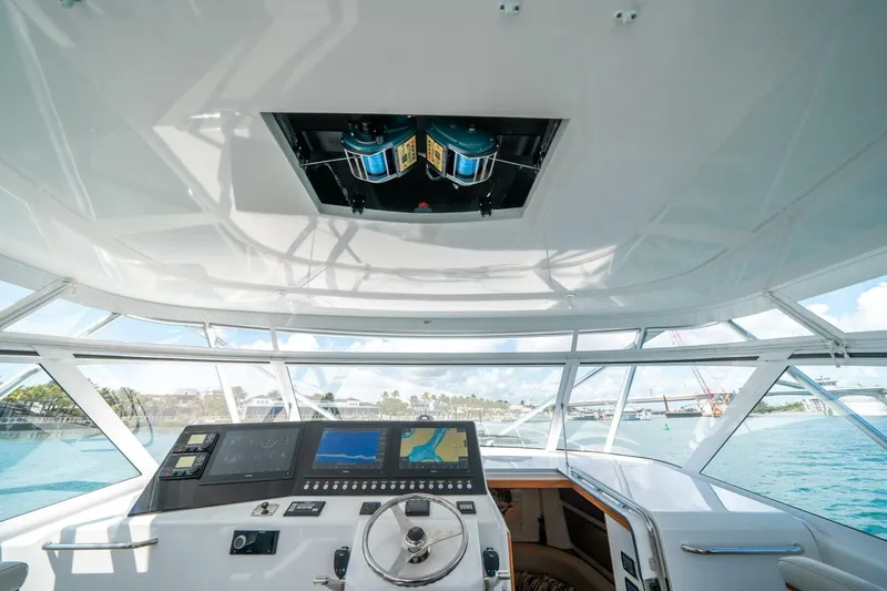 Slide: The Image of Helm of 2020 Cabo 40 Express yacht with navigation screens and steering wheel. - 53