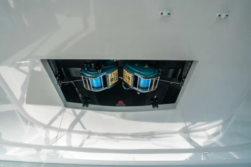 Slide: The Image of Fishing equipment on 2020 Cabo 40 Express boat, featuring dual reels in a compartment. - 54