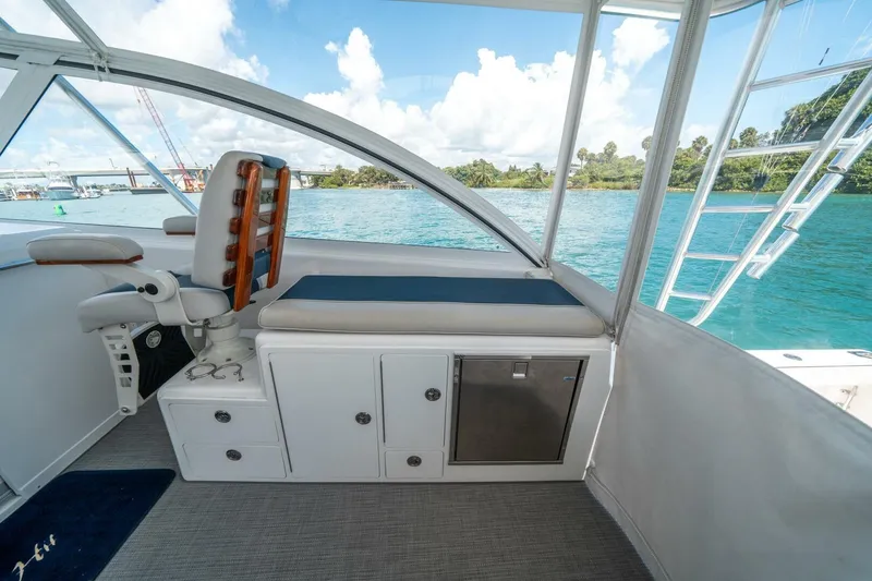 Slide: The Image of 2020 Cabo 40 Express boat interior with seating, storage, and ocean view. - 57