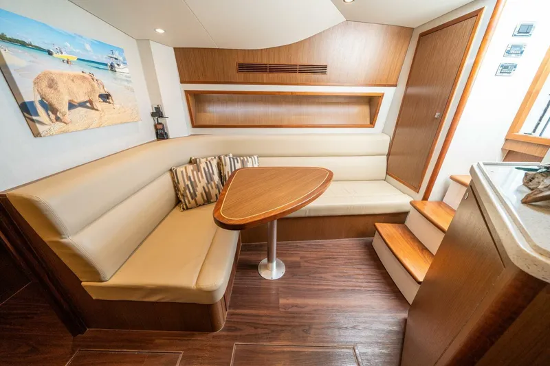 Slide: The Image of Luxurious interior of 2020 Cabo 40 Express yacht with cozy seating and wooden accents. - 7
