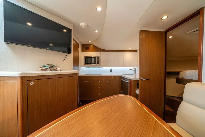 Slide: The Image of Luxurious interior of 2020 Cabo 40 Express yacht with modern kitchen and TV. - 9