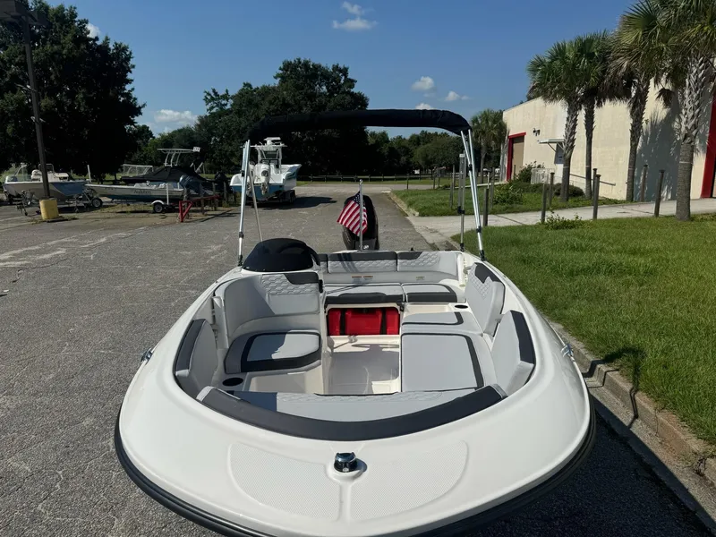 Slide: The Image of 2024 Bayliner Element M15 boat with seating, parked outdoors on a sunny day. - 11
