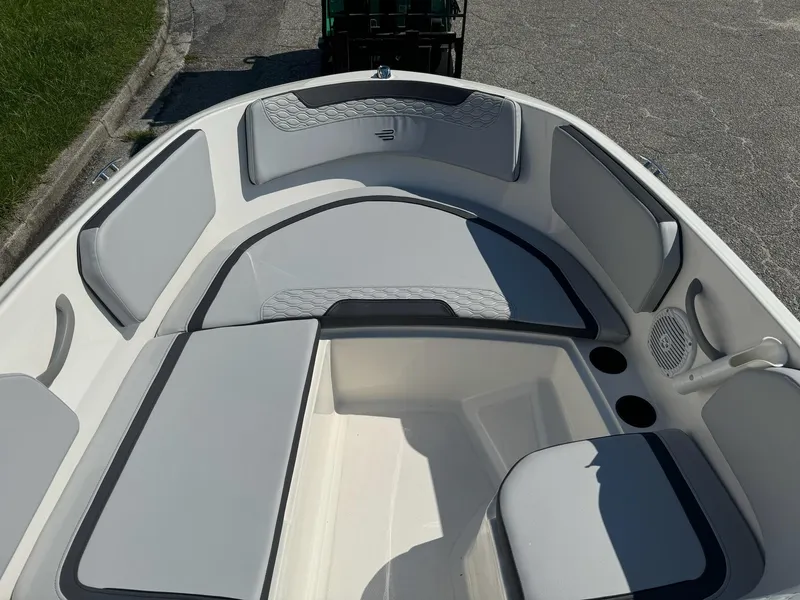 Slide: The Image of 2024 Bayliner Element M15 boat interior with gray seating and cup holders. - 12