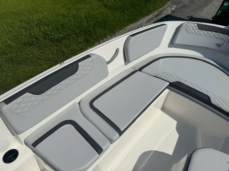 Slide: The Image of 2024 Bayliner Element M15 boat interior with gray and black cushioned seating. - 14
