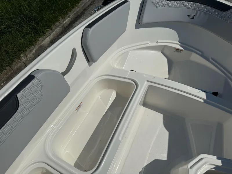 Slide: The Image of 2024 Bayliner Element M15 boat interior with storage compartments and cushioned seating. - 16