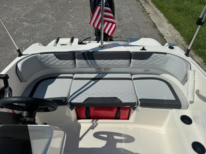 Slide: The Image of 2024 Bayliner Element M15 boat interior with seating and American flag. - 17