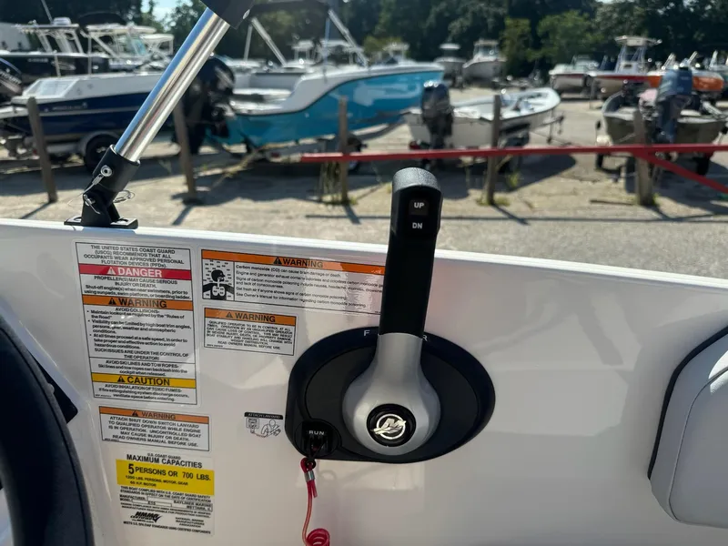 Slide: The Image of 2024 Bayliner Element M15 boat controls with safety warnings and capacity details. - 19