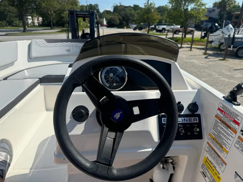Slide: The Image of 2024 Bayliner Element M15 boat dashboard with steering wheel and controls. - 20