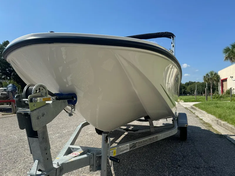 Slide: The Image of 2024 Bayliner Element M15 boat on trailer under clear blue sky. - 4