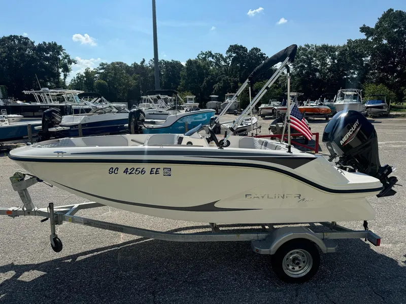 Slide: The Image of 2024 Bayliner Element M15 boat on trailer in a marina setting. - 5