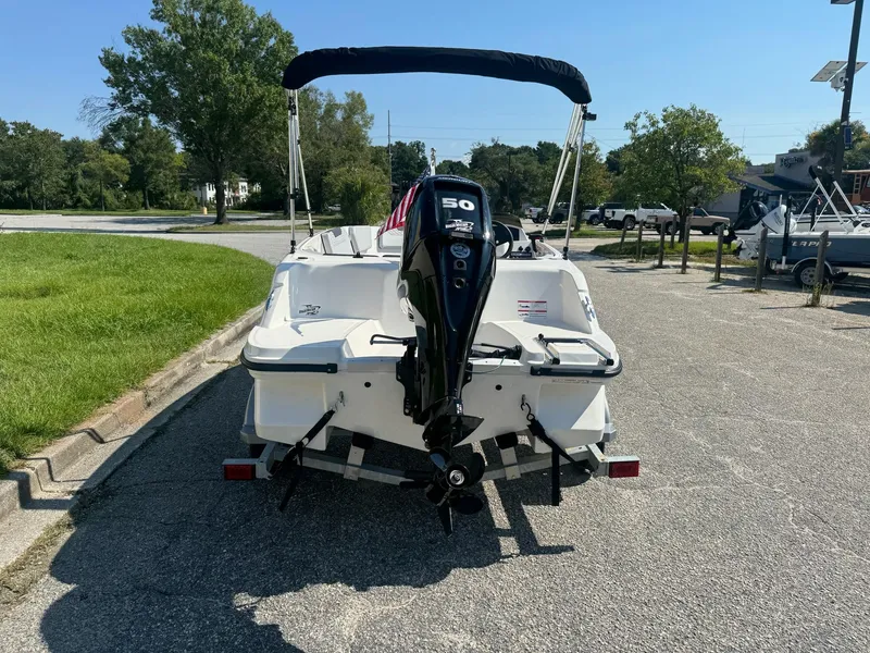Slide: The Image of 2024 Bayliner Element M15 boat with outboard motor, parked on a sunny day. - 7