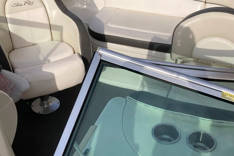 Slide: The Image of 2012 Sea Ray 200 Sundeck interior with seating and windshield view. - 13