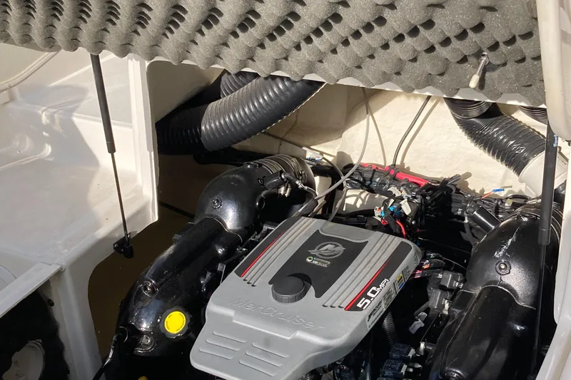 Slide: The Image of Engine compartment of a 2012 Sea Ray 200 Sundeck boat, showcasing the motor and components. - 14