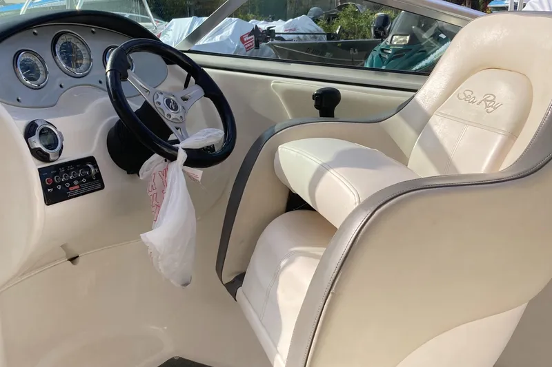 Slide: The Image of 2012 Sea Ray 200 Sundeck boat interior with steering wheel and dashboard. - 5