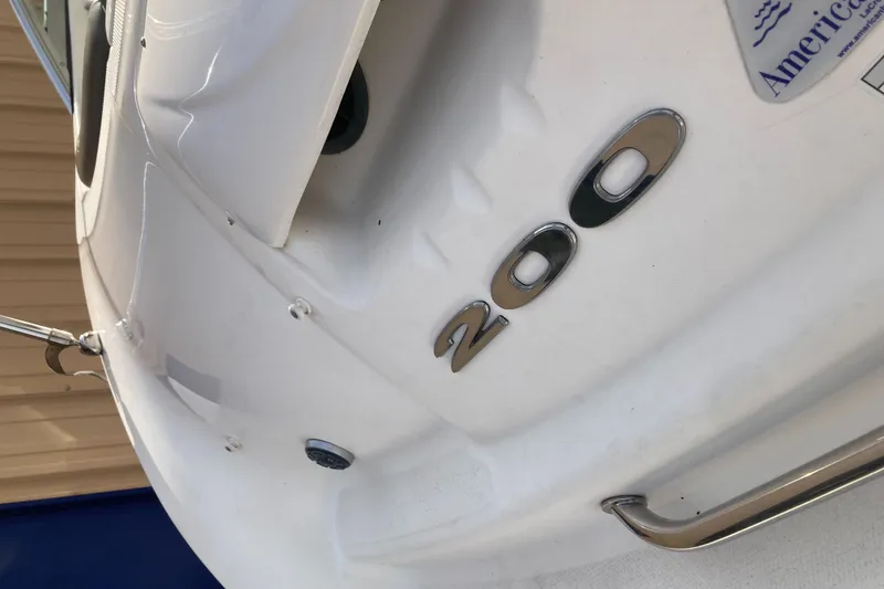 Slide: The Image of 2012 Sea Ray 200 Sundeck boat, close-up of model number on white hull. - 7