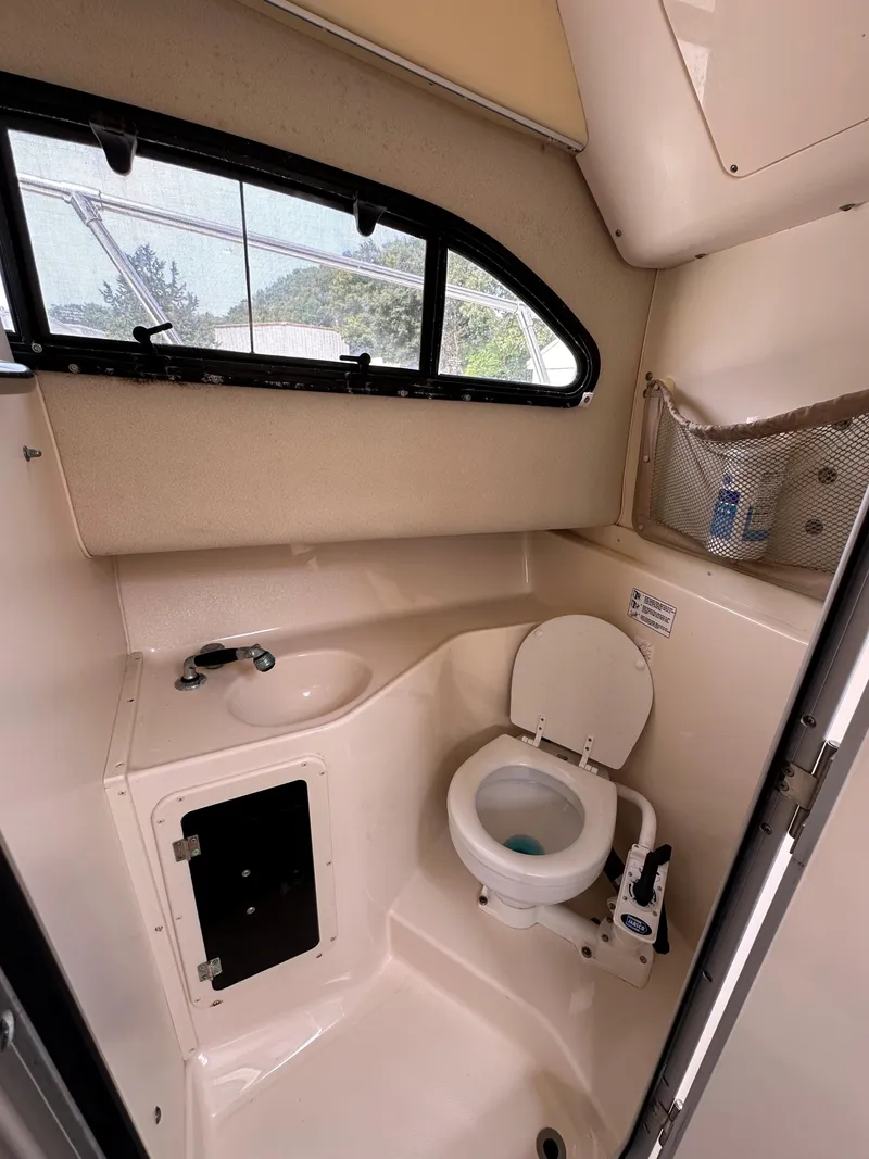 Slide: The Image of 2001 Grady-White 282 Sailfish boat bathroom with sink and toilet. - 10