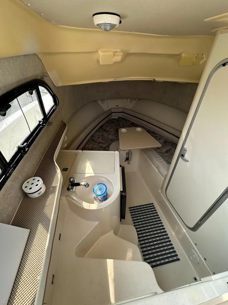 Slide: The Image of Interior of 2001 Grady-White 282 Sailfish boat, featuring compact cabin and amenities. - 11