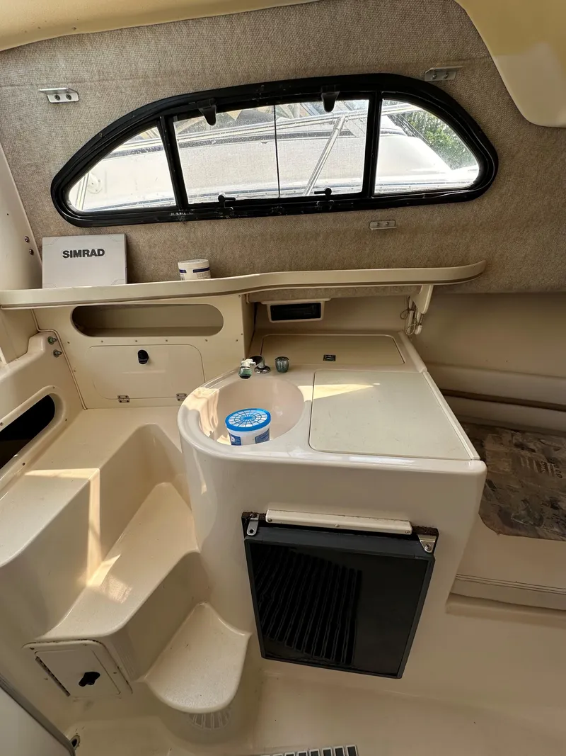 Slide: The Image of Interior of 2001 Grady-White 282 Sailfish boat with kitchenette and window. - 12