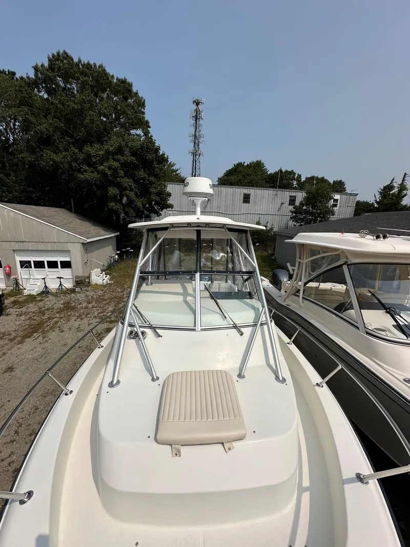 Slide: The Image of 2001 Grady-White 282 Sailfish boat docked, featuring a spacious deck and sturdy railings. - 15