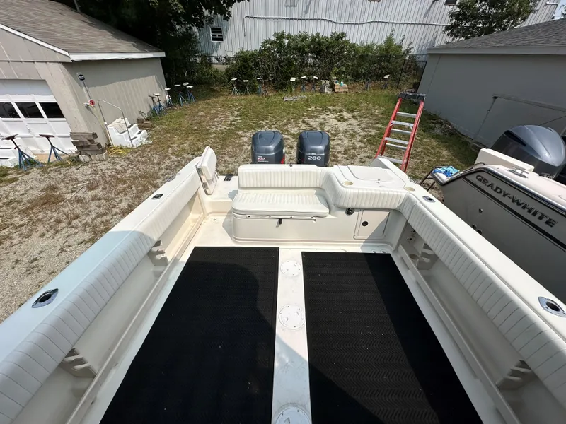 Slide: The Image of 2001 Grady-White 282 Sailfish boat interior with seating and twin engines in a yard. - 7