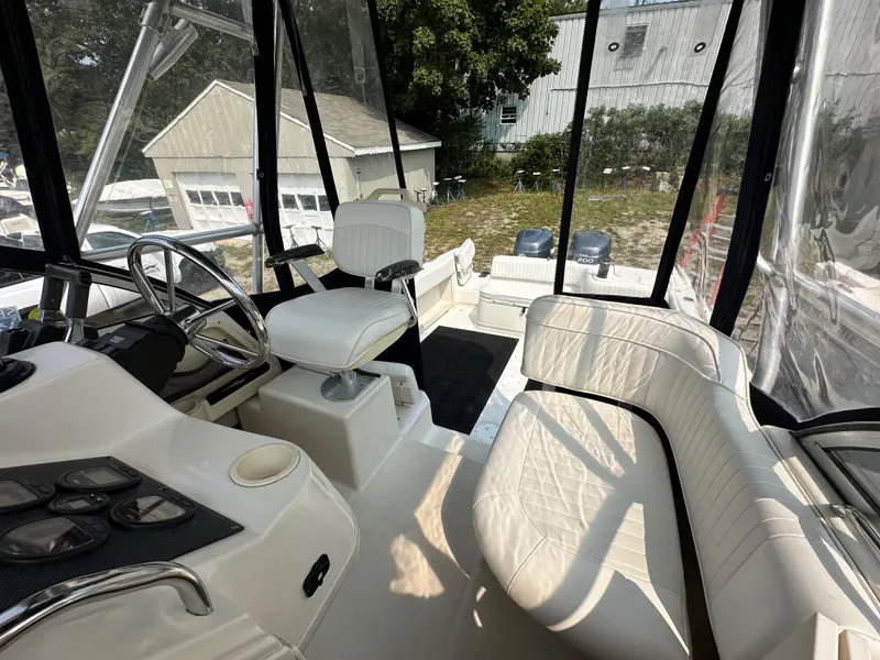Slide: The Image of Interior of 2001 Grady-White 282 Sailfish boat with white seating and steering wheel. - 9