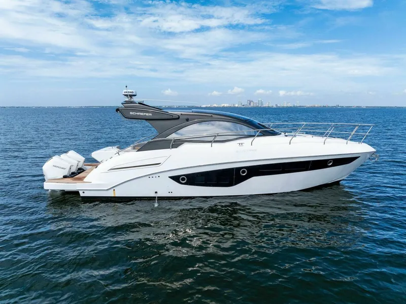 Slide: The Image of 2022 Schaefer 400 Coupe yacht cruising on open water under a clear sky. - 1