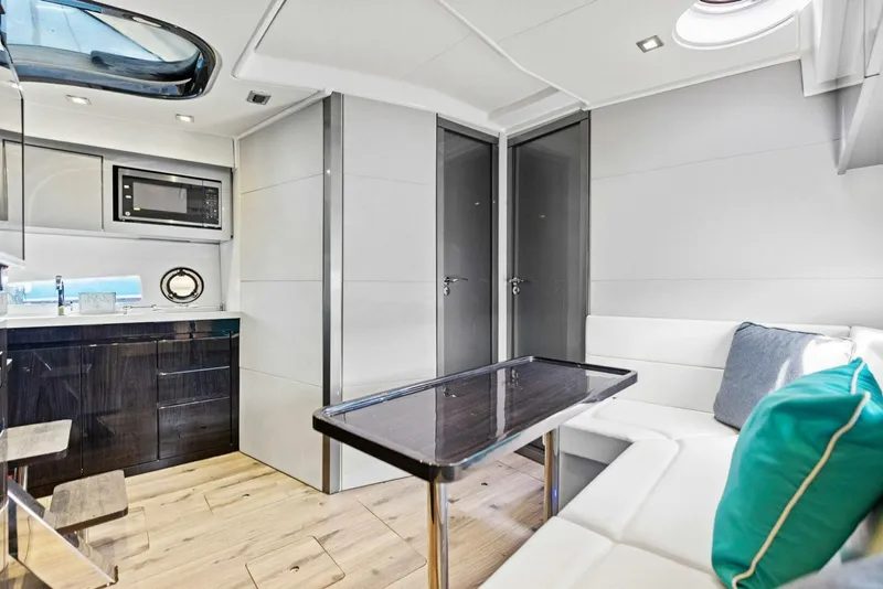 Slide: The Image of Luxurious interior of 2022 Schaefer 400 Coupe yacht with modern kitchen and seating area. - 10