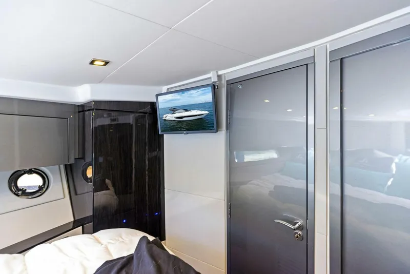 Slide: The Image of Interior of 2022 Schaefer 400 Coupe yacht cabin with modern design and TV. - 13
