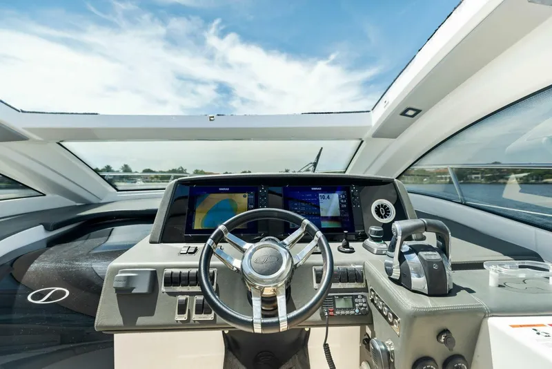 Slide: The Image of Interior cockpit of 2022 Schaefer 400 Coupe yacht with modern navigation controls. - 2