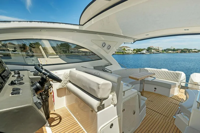 Slide: The Image of Luxurious 2022 Schaefer 400 Coupe yacht interior with elegant seating and scenic water view. - 21