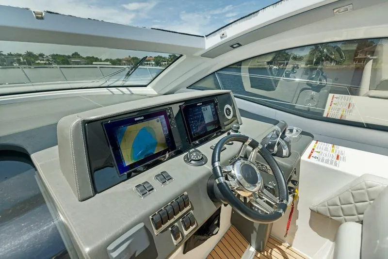 Slide: The Image of Schaefer 400 Coupe 2022 yacht helm with modern navigation displays and controls. - 23