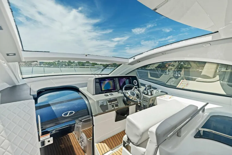 Slide: The Image of Luxurious 2022 Schaefer 400 Coupe yacht interior with modern helm and panoramic views. - 27