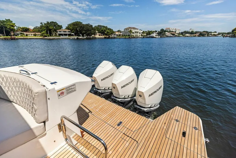 Slide: The Image of 2022 Schaefer 400 Coupe with triple Mercury outboards on a serene lake. - 32