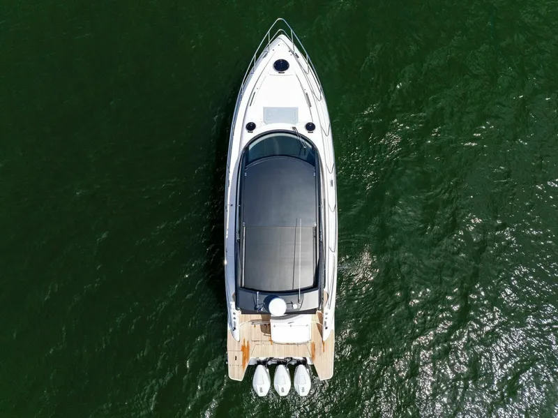 Slide: The Image of Aerial view of 2022 Schaefer 400 Coupe yacht on green water. - 38